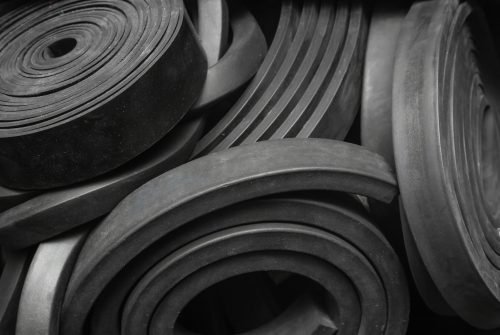Close-up rubber sealing strips for waterproof doors. A pile of rubber twisted into rolls. Close-up rubber sealing strips for waterproof doors. A pile of rubber twisted into rolls.