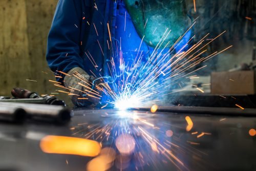 Welder in his workshop welding metal Welder in his workshop welding metal, lots of sparks flying around